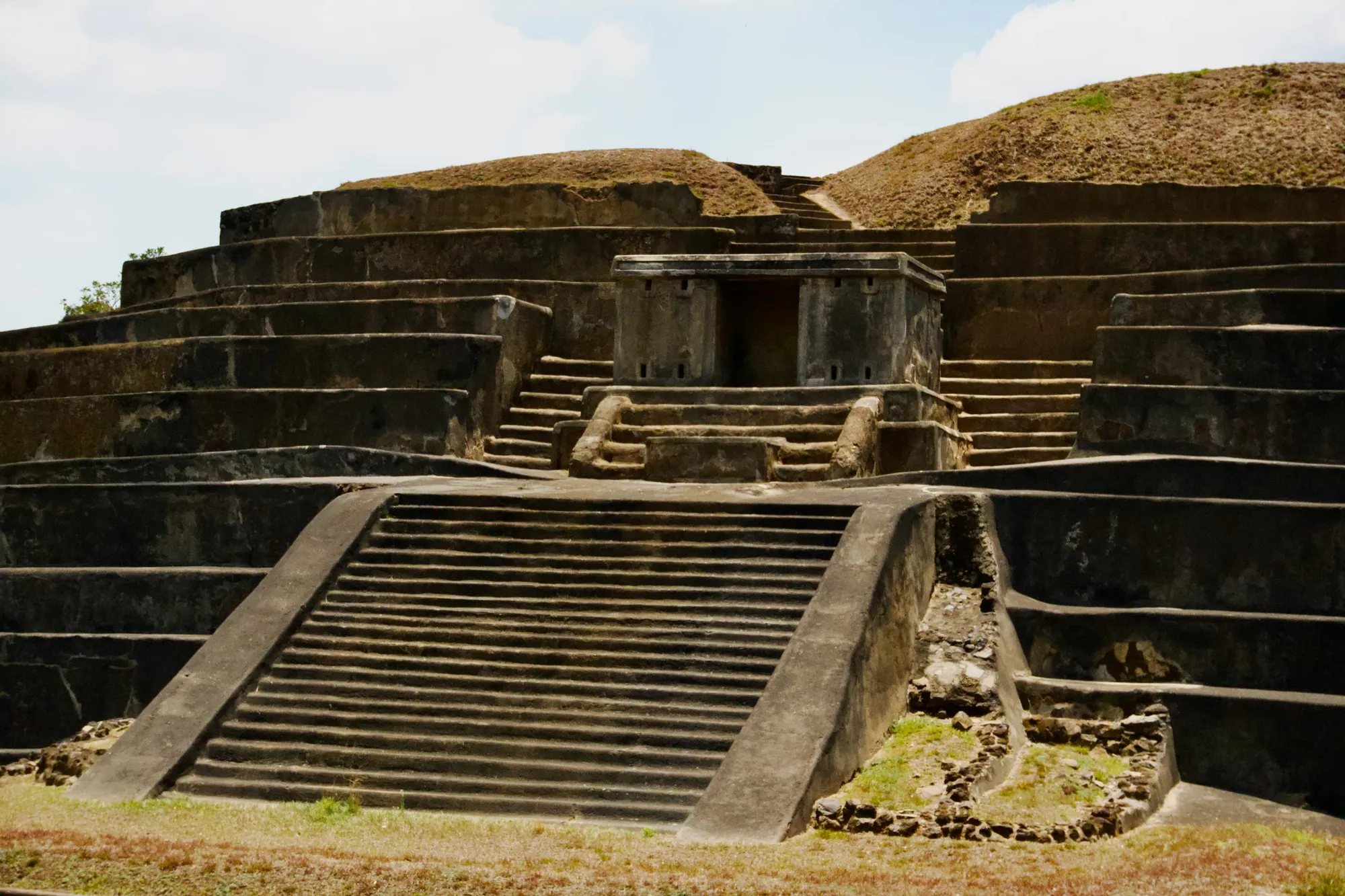 The main pyramid at Tazumal, its stepped terraces and broad central staircase restored in concrete